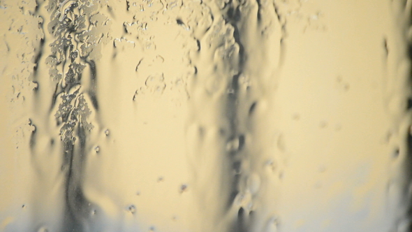 Drops of Rain Sliding Down in a Window alt