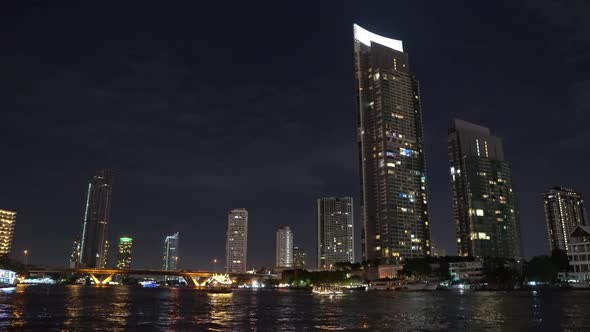 corporate buildings of the metropolis at night on the river bank. business center of a lively city.