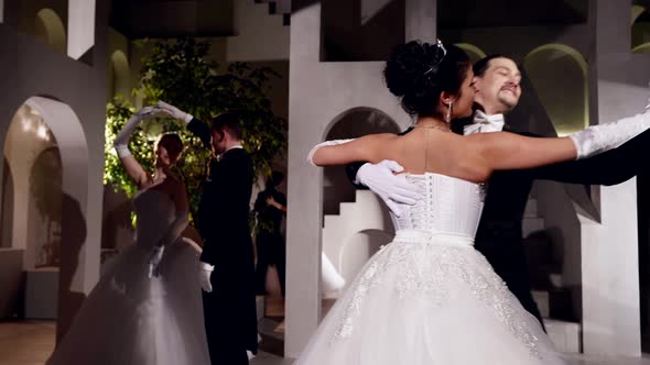 Passionate Ballroom Dancers Move Across a Dark Stage