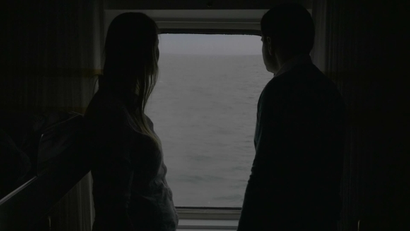 Couple Looking At Sea From a Cabin Of The Cruise