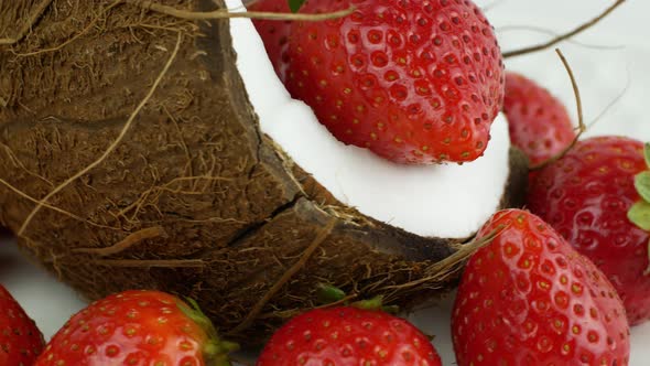 Rotation of juicy strawberries and coconut. Top view, 360 degree rotation, extreme close-up.