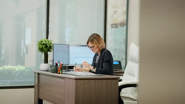 Woman Sit at Desk Using Computer Make Data Analysis Check Statistics Research Workday in Office