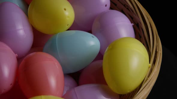 Rotating shot of Easter decorations and candy in colorful Easter grass 