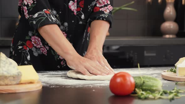 Preparing dough for pizza