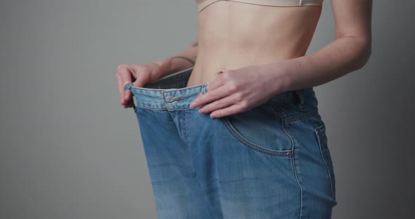 Young Woman Shows her Weight Loss and Wearing Her Old Jeans