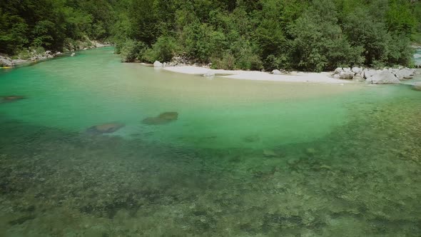 Aerial view of the calm and transparent water at the Soca river in Slovenia.