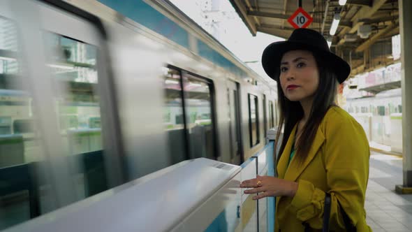 Japanese woman waiting for a train in Tokyo Japan