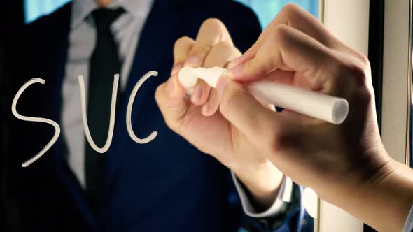 Smart Business Man Writing the Word SUCCESS on the Mirror Board