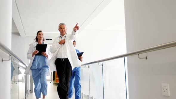 Doctors and nurse running in passageway of hospital