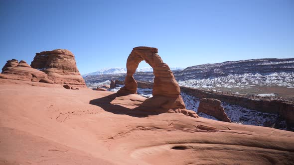 Delicate Arch with snow-covered La Sal mountains in the background, static