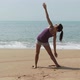Young woman practicing yoga by the sea - VideoHive Item for Sale