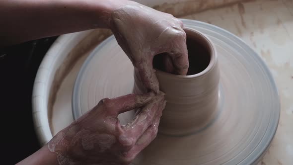 A Woman Sculptor Works on a Potter's Wheel