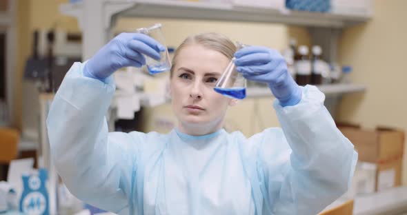 Scientist Mixing Liquid at Laboratory