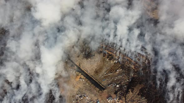 Aerial view white smoke release during wild fire burning