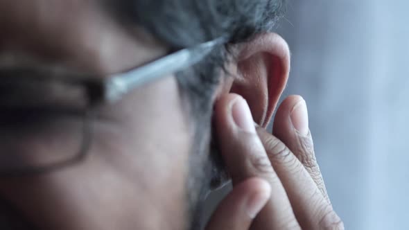 Young Man Having Ear Pain Touching His Painful Ear