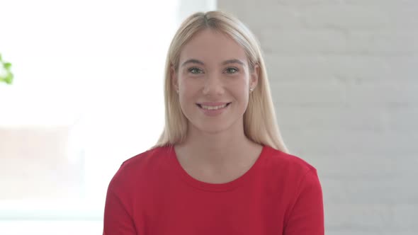 Young Blonde Woman Smiling at Camera