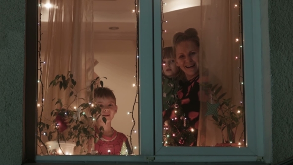 Christmas, Mother And Children Run Up To a Window