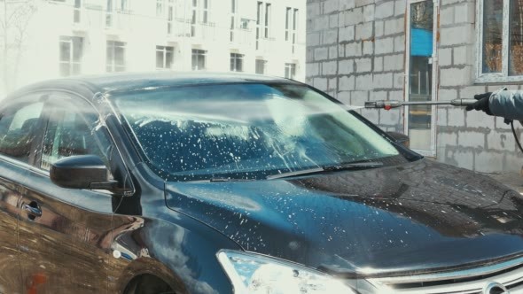 Washing The Car With High Pressure Washer