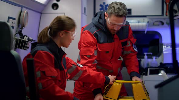 Rescue Team of Paramedics Preparing Medical Equipment for First Aid