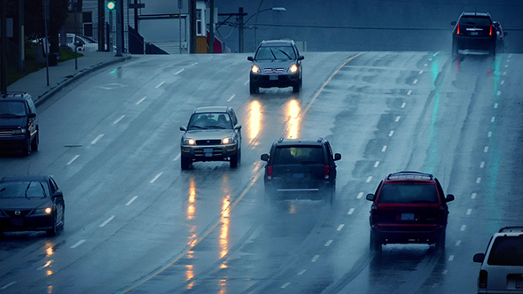 Cars Driving On Wet Road In Rain Shower alt