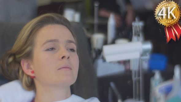 Woman Stylist Beautician Wipes a Eyeliner Applied