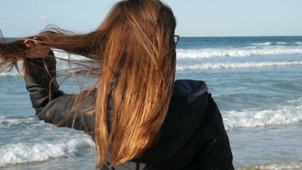 Girl With Long Red Hair On The Beach