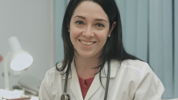 Cute Female Doctor Smiling And Says Good News