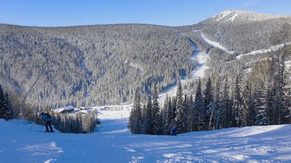 Skiers And Snowboarders Are Riding On Downhill