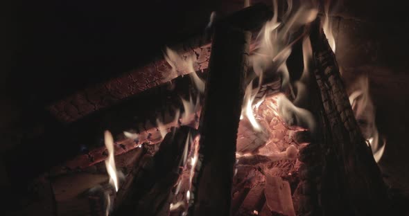 Close Up Footage of the Big Fire with Firewood at Night Brick Walls of the Fireplace Bonfire Burning