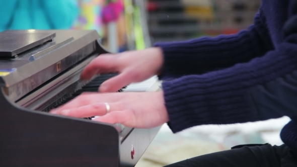 Pianist In The Mask Plays The Piano On The Street
