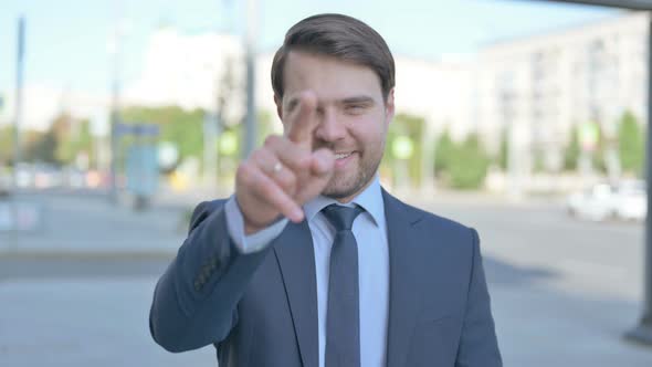 Businessman Pointing at the Camera Outdoor