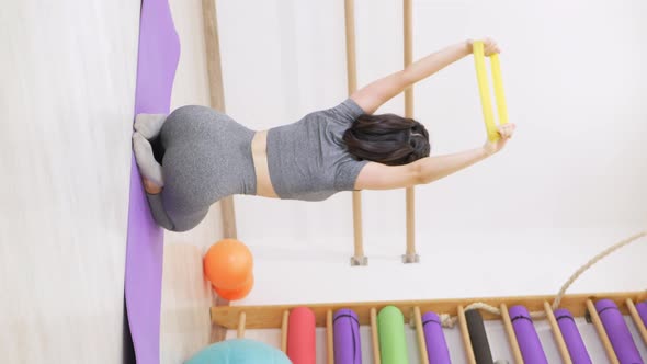 Young Woman is Doing Gymnastics in Gym