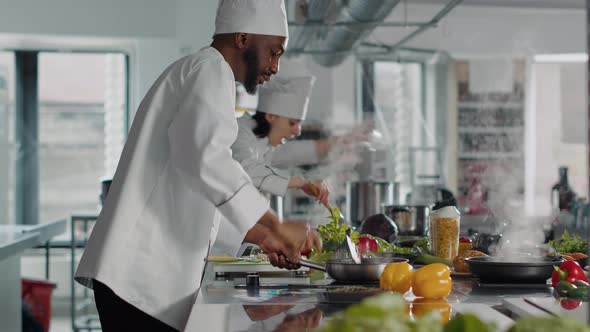 Professional Cook Preparing Tasty Meal with Rosemary Leaves