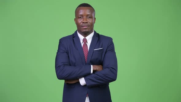 Young Happy African Businessman with Arms Crossed