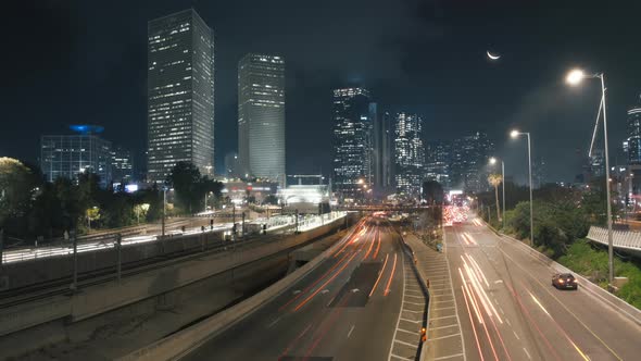 The Moon rising above night cityscape