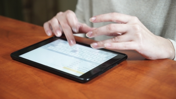 Woman Hands Working On Tablet Computer In Office