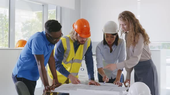 Diverse Engineering Team Meeting to Discuss Architectural Project and Smiling at Camera