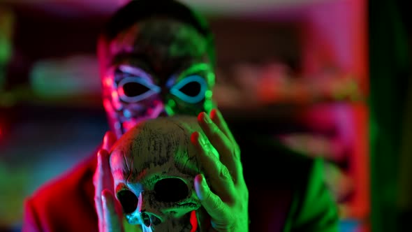 Mystery of Death and Black Magic Man with Skull Mask is Playing with Human Skull Serial Killer