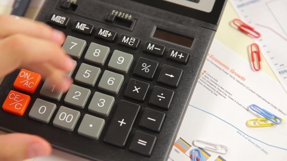 Businessman Counting On a Calculator