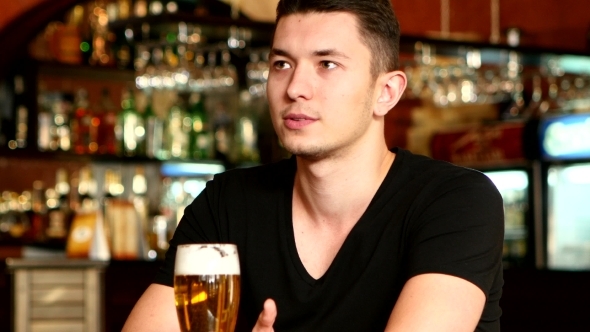 Boy Sitting In Bar And Watching Sport