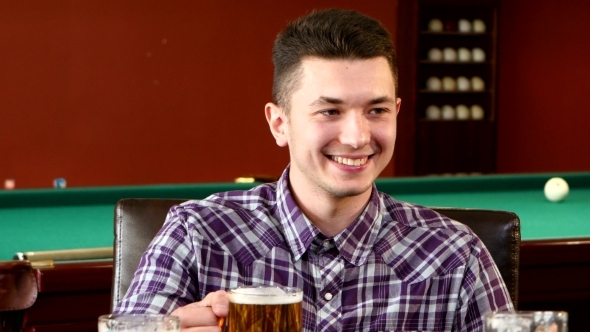 Boy Sitting In Bar With Friends alt