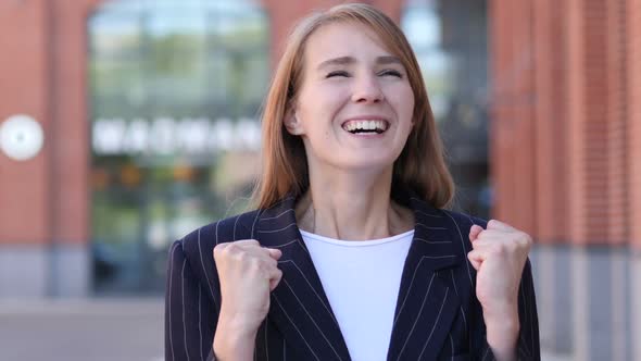 Business Woman Celebrating Success Gesture in Office