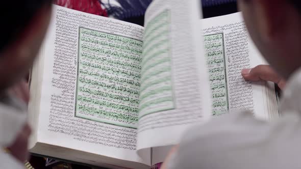 Indian muslim men reading Quran