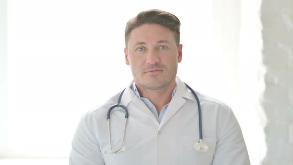 Portrait of Serious Male Doctor Looking at the Camera