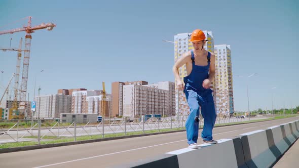 Happy Caucasian Man Builder in Hard Hat Dancing. Worker Funny Moves Background Construction Site.