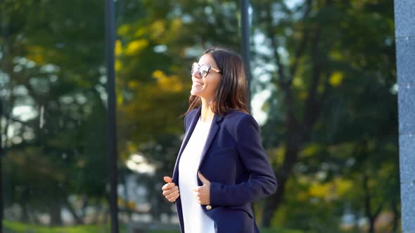 Beautiful Businesswoman Coming Out From Office Building in Excellent Mood