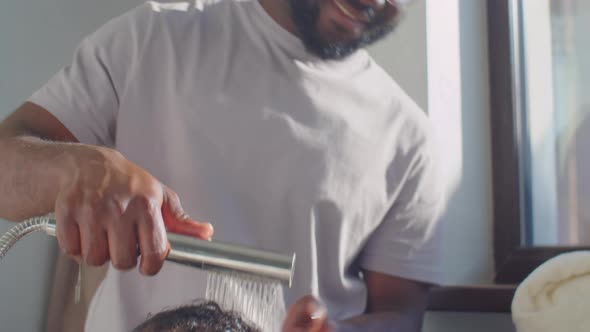 African American Boy Bathing with Dad at Home