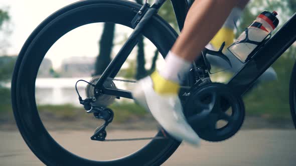 Cyclist Riding On Carbon Bike In Lycra Sportswear. Muscular Fitness Biker Cycling Workout.