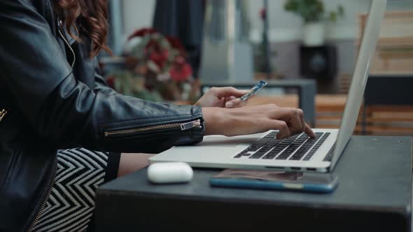 Young Woman Holding Credit Card and Using Laptop Computer