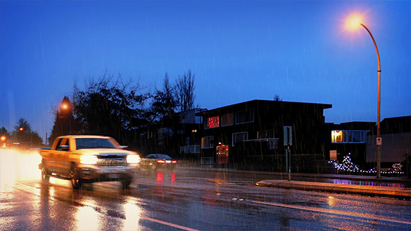 Cars Pass Houses In Dramatic Stormy Weather alt
